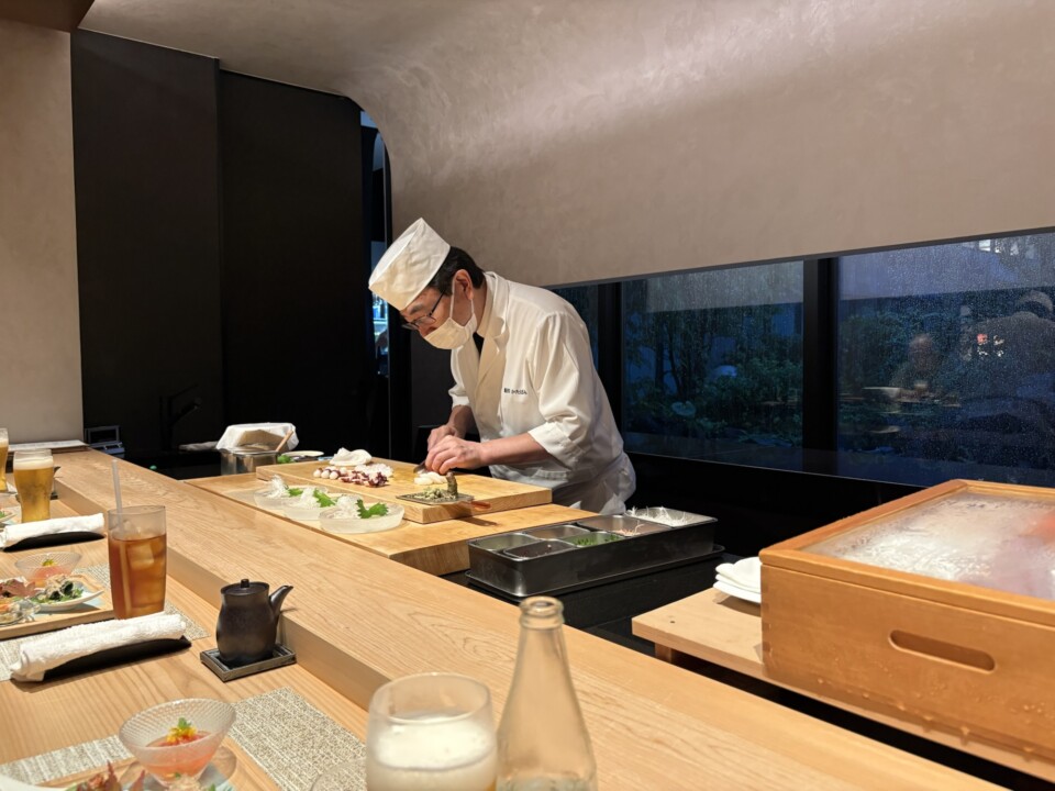 The nine-seat counter at Katabami, facing the hotel courtyard, with the chef preparing sushi